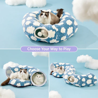 Blue pet bed with cloud pattern and tunnel, featuring cats inside on a light blue background.
