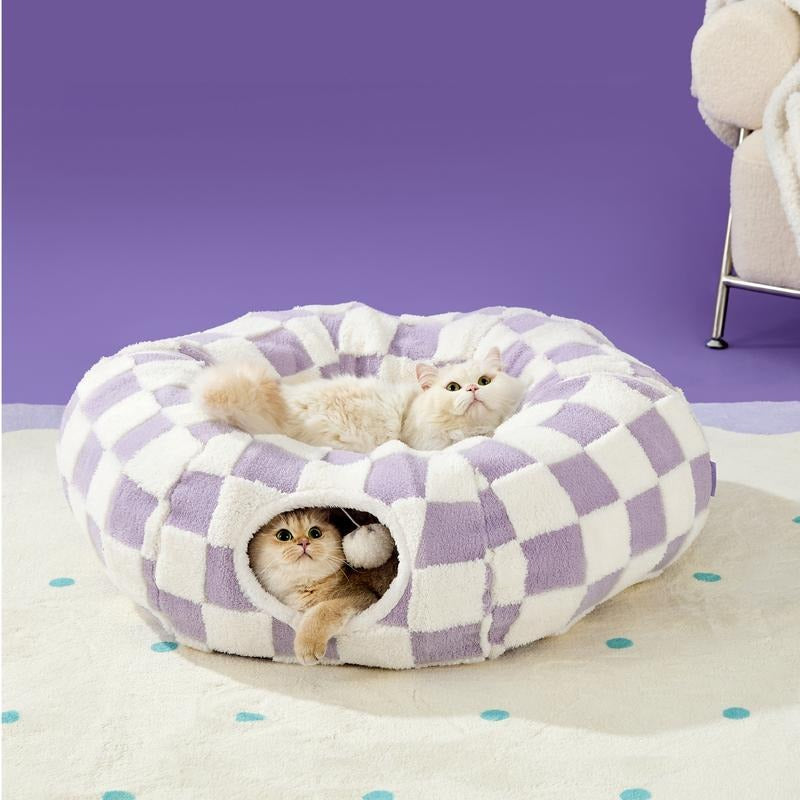 Checkered pet bed with cats inside on a purple background